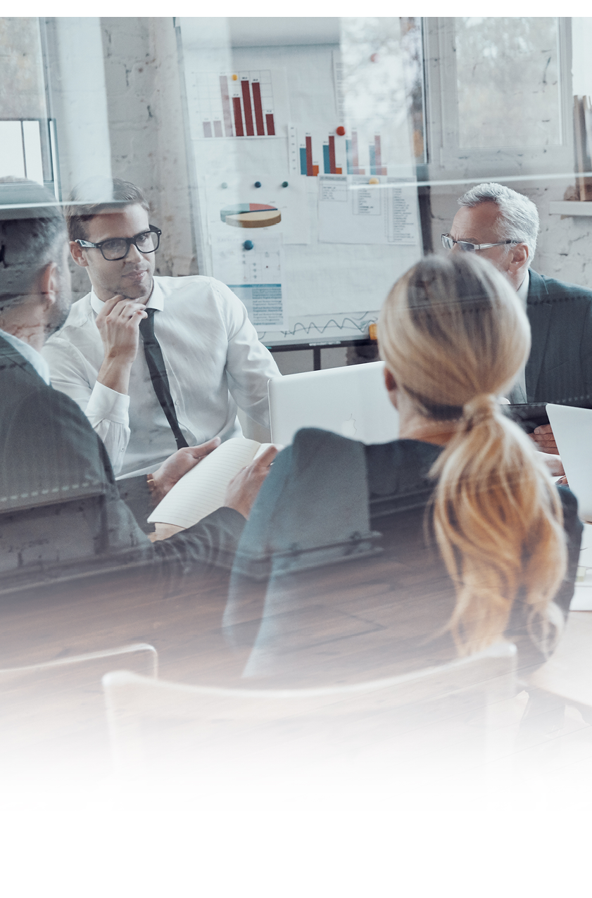 Successful business team discussing strategy while filming staff meeting in the board room